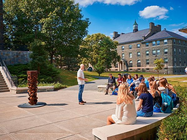Professor Peter Klepeis teaches a course on "The Geography of Happiness" to first-year students on a sunny afternoon outside the Ho Science Center.