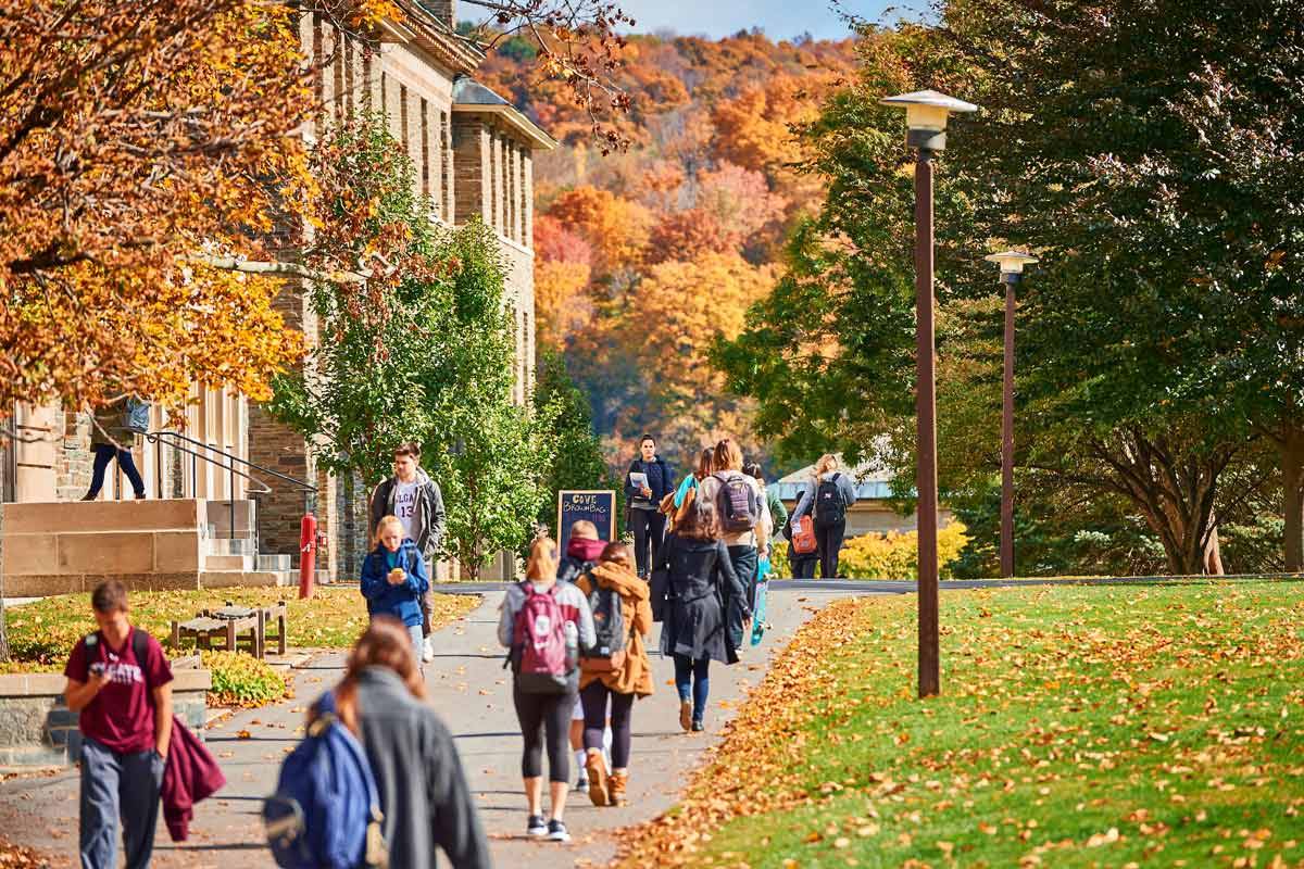 Students walk to class on the academic quad on a beautiful autumn day.